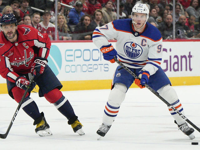 WASHINGTON, DC - NOVEMBER 07: Connor McDavid #97 of the Edmonton Oilers skates with the puck as Alex Ovechkin #8 of the Washington Capitals defends during the third period at Capital One Arena on November 07, 2022 in Washington, DC. This is McDavid's 500th career game.