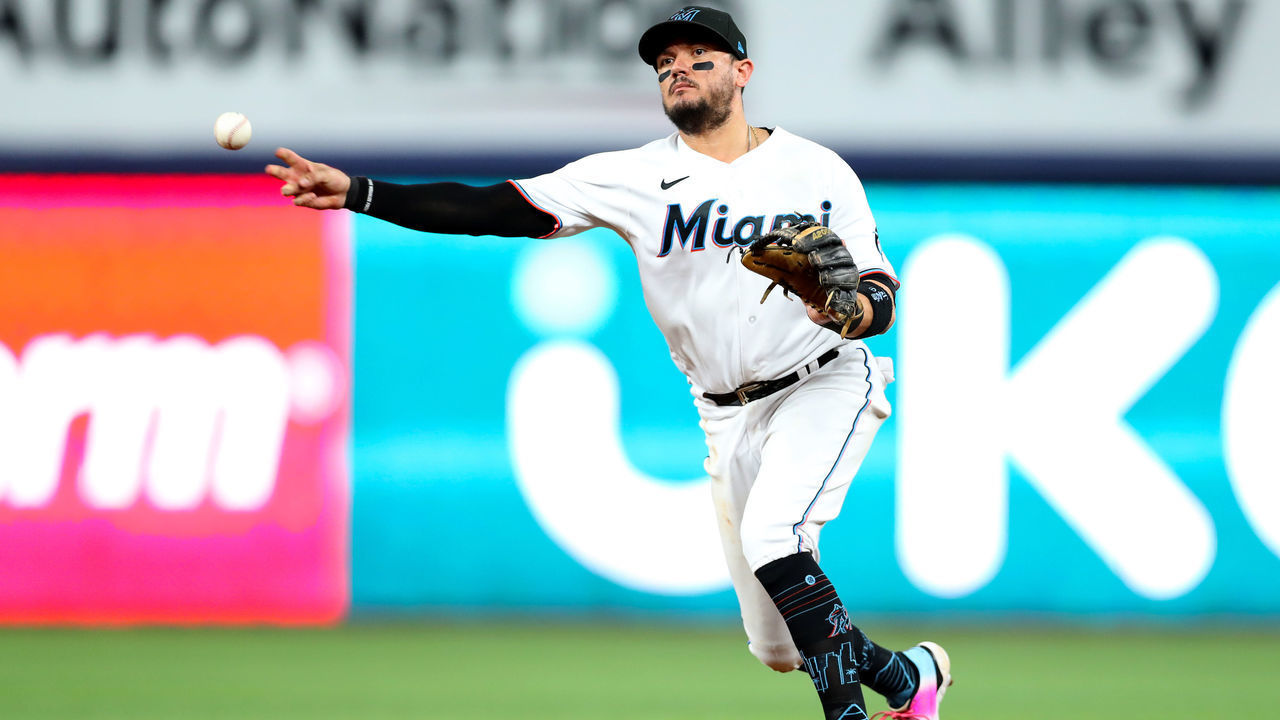 MIAMI, FLORIDA - OCTOBER 03: Miguel Rojas #11 of the Miami Marlins throws to first base during the eighth inning against the Atlanta Braves at loanDepot park on October 03, 2022 in Miami, Florida.
