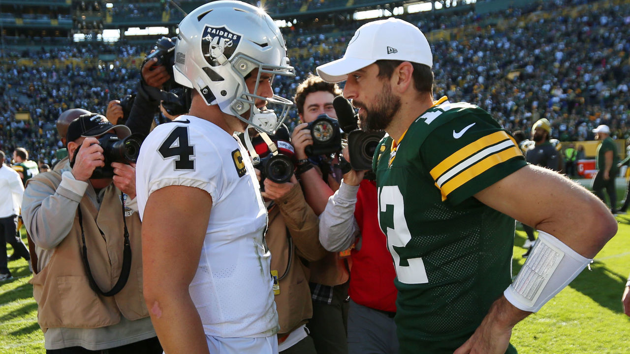 GREEN BAY, WI - OCTOBER 20: Green Bay Packers quarterback Aaron Rodgers (12) and Oakland Raiders quarterback Derek Carr (4) talk during a game between the Green Bay Packers and the Oakland Raiders at Lambeau Field on October 20, 2019 in Green Bay, WI.
