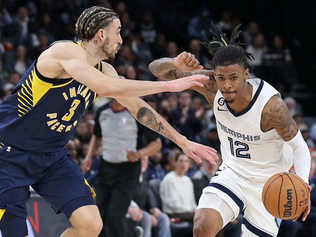 MEMPHIS, TENNESSEE - JANUARY 29: Ja Morant #12 of the Memphis Grizzlies handles the ball against Chris Duarte #3 of the Indiana Pacers during the game at FedExForum on January 29, 2023 in Memphis, Tennessee.