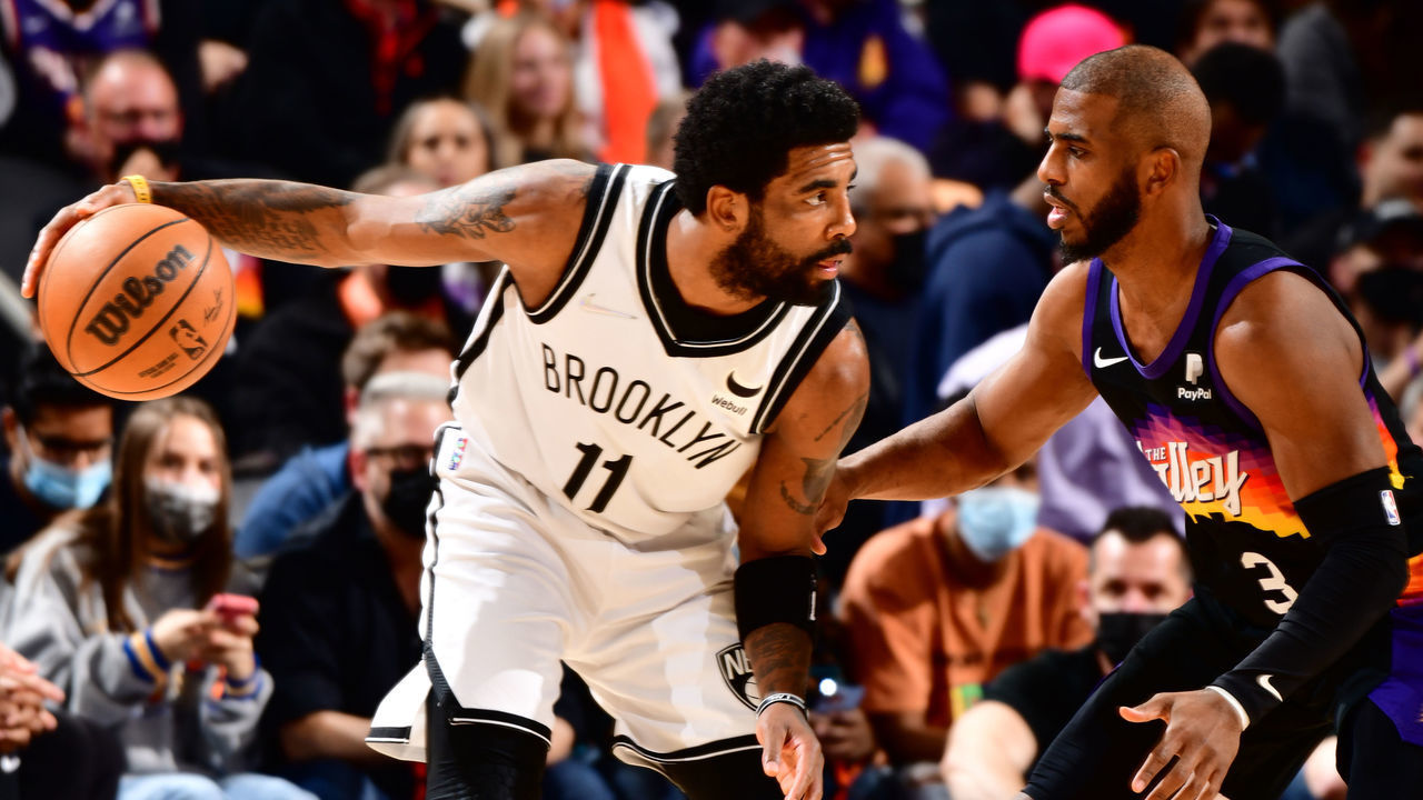 PHOENIX, AZ - FEBRUARY 1: Chris Paul #3 of the Phoenix Suns plays defense on Kyrie Irving #11 of the Brooklyn Nets during the game on February 1, 2022 at Footprint Center in Phoenix, Arizona. Mandatory Copyright Notice: Copyright 2022 NBAE