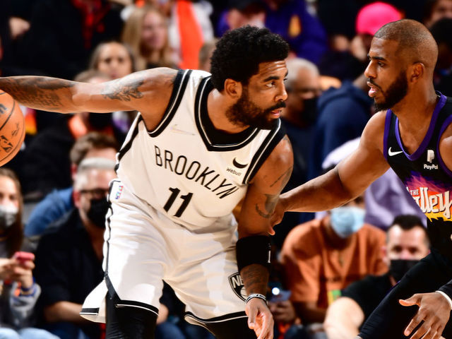PHOENIX, AZ - FEBRUARY 1: Chris Paul #3 of the Phoenix Suns plays defense on Kyrie Irving #11 of the Brooklyn Nets during the game on February 1, 2022 at Footprint Center in Phoenix, Arizona. Mandatory Copyright Notice: Copyright 2022 NBAE
