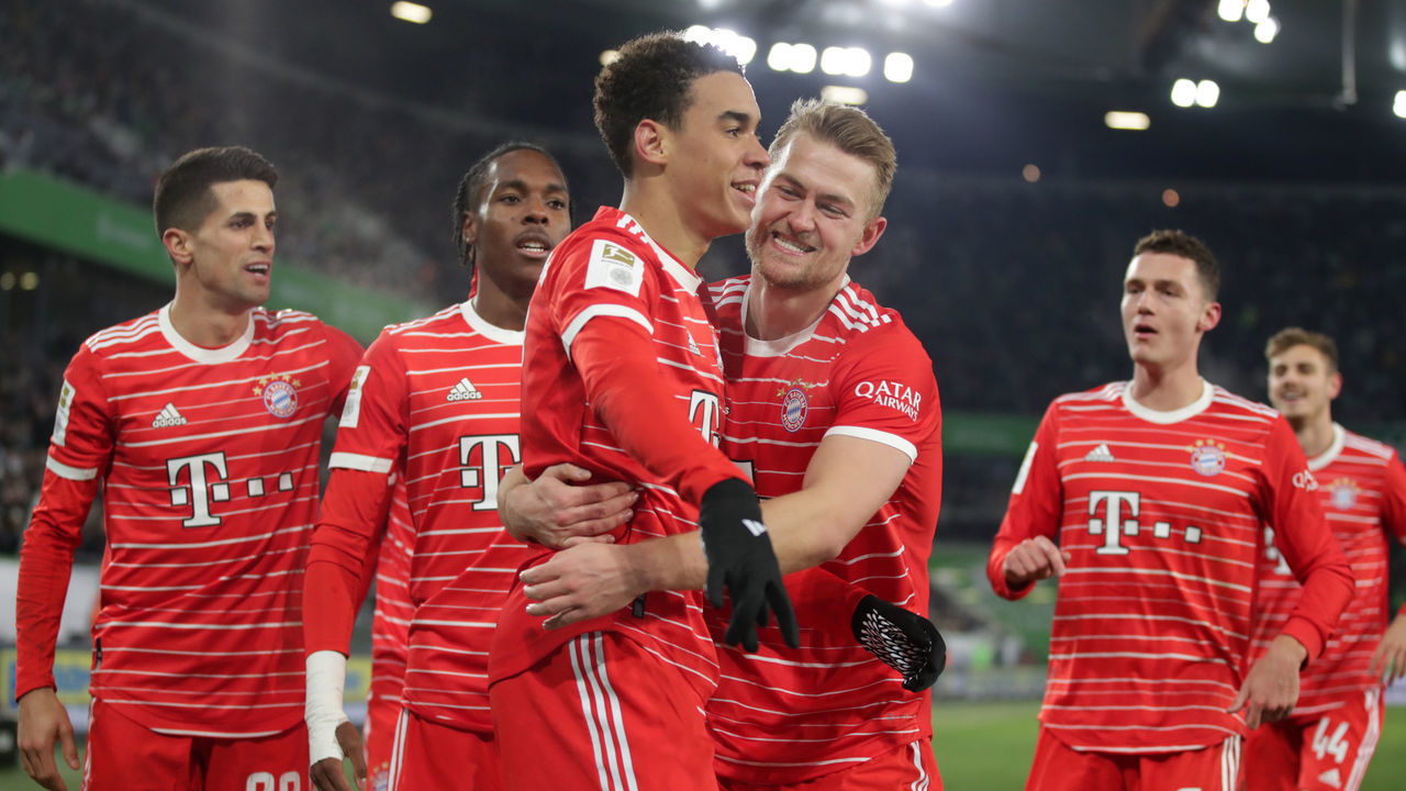 WOLFSBURG, GERMANY - FEBRUARY 05: Jamal Musiala of Bayern Muenchen celebrates as he scores the goal 1:4 with Matthijs de Ligt of FC Bayern Muenchen and Mathys Tel of FC Bayern Muenchen during the Bundesliga match between VfL Wolfsburg and FC Bayern München at Volkswagen Arena on February 05, 2023 in Wolfsburg, Germany.