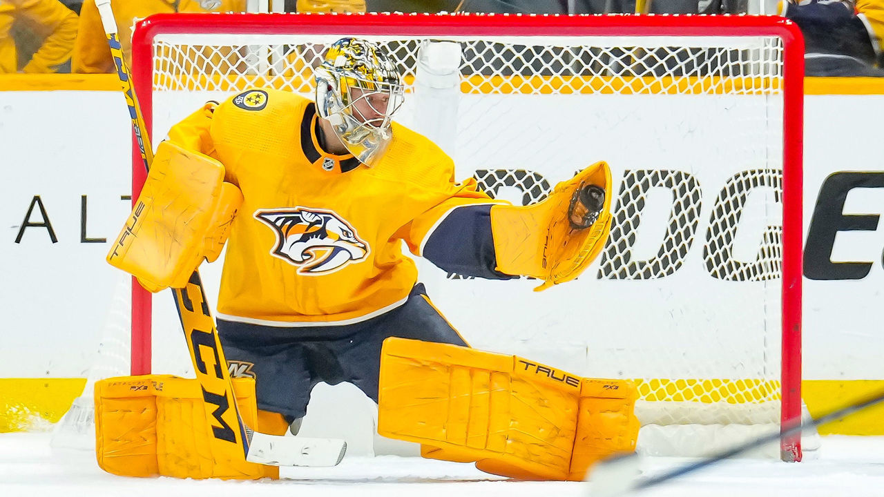 NASHVILLE, TENNESSEE - JANUARY 14: Juuse Saros #74 of the Nashville Predators makes a glove save against the Buffalo Sabres during an NHL game at Bridgestone Arena on January 14, 2023 in Nashville, Tennessee.