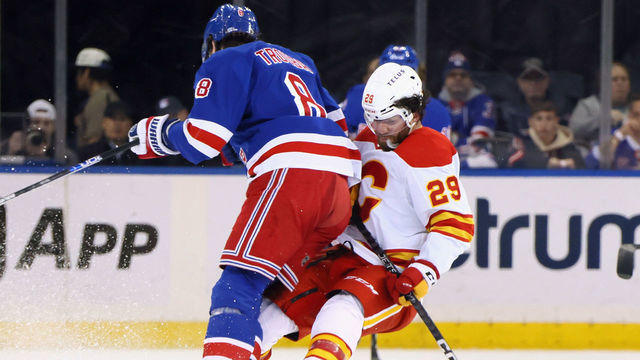 NEW YORK, NEW YORK - FEBRUARY 06: Jacob Trouba #8 of the New York Rangers steps into Dillon Dube #29 of the Calgary Flames during the first period at Madison Square Garden on February 06, 2023 in New York City.