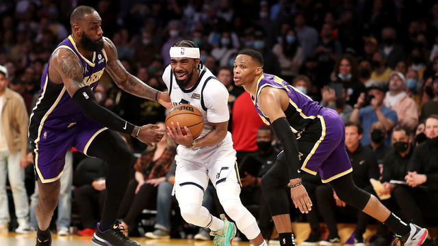 LOS ANGELES, CALIFORNIA - FEBRUARY 16: Mike Conley #11 of the Utah Jazz drives to the basket against LeBron James #6 and Russell Westbrook #0 of the Los Angeles Lakers during the fourth quarter at Crypto.com Arena on February 16, 2022 in Los Angeles, California.