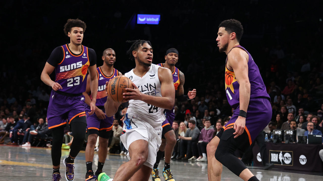NEW YORK, NEW YORK - FEBRUARY 07: Cam Thomas #24 of the Brooklyn Nets drives against Devin Booker #1 of the Phoenix Suns during their game at Barclays Center on February 07, 2023 in New York City. User expressly acknowledges and agrees that, by downloading and or using this photograph, User is consenting to the terms and conditions of the Getty Images License Agreement.