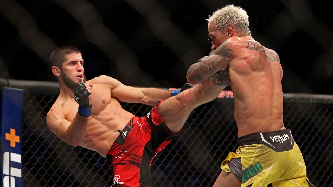 Islam Makhachev (L) competes against Charles Oliveira in the lightweight championship at the Ultimate Fighting Championship (UFC) event at the Etihad Arena in Abu Dhabi on October 22, 2022.