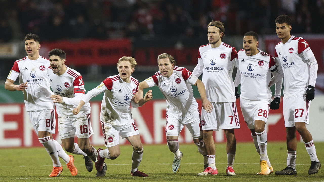 NUREMBERG, GERMANY - FEBRUARY 08: Players of 1. FC Nürnberg react after winning the penalty shoot out after the DFB Cup round of 16 match between 1. FC Nürnberg and Fortuna Düsseldorf at Max-Morlock-Stadion on February 08, 2023 in Nuremberg, Germany.