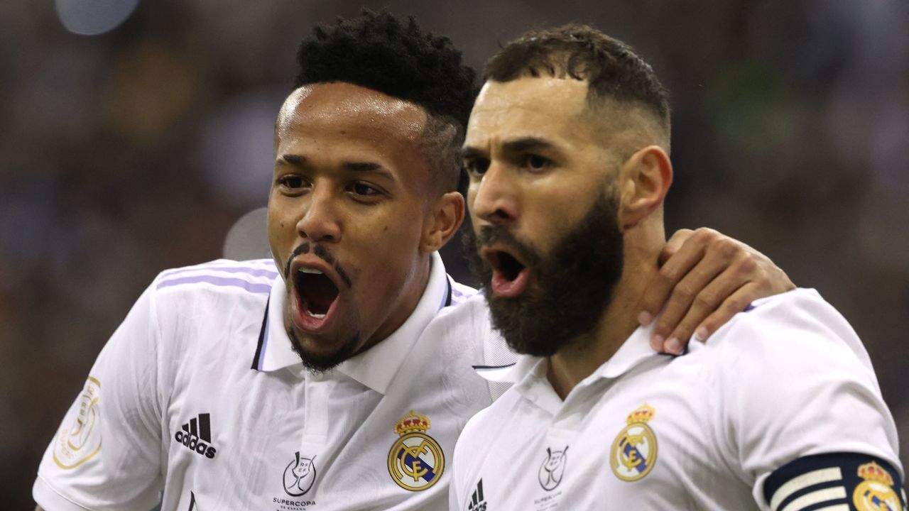 Real Madrid's French forward Karim Benzema (R) celebrates scoring the opening goal from the penalty spot, next to Real Madrid's Brazilian defender Eder Militao during the Spanish Super Cup semi-final football match between Real Madrid CF and Valencia CF at the King Fahd International Stadium in Riyadh, Saudi Arabia, on January 11, 2023.