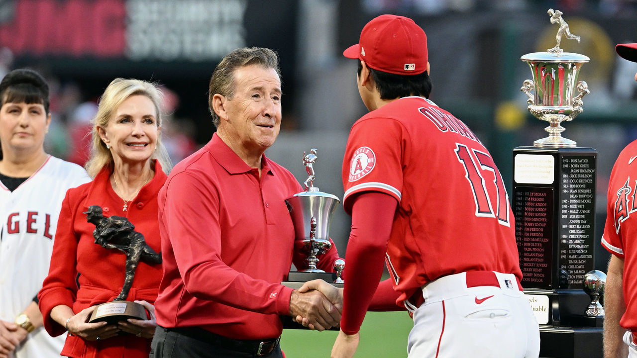 ANAHEIM, CA - OCTOBER 01: Los Angeles Angels Shohei Ohtani (17) receives the team MVP Award from team owner Arte Moreno while his wife Carole holds onto the Nick Adenhart Award for Ohtani on the field before the start of an MLB baseball game against the Texas Rangers played on October 1, 2022 at Angel Stadium in Anaheim, CA.