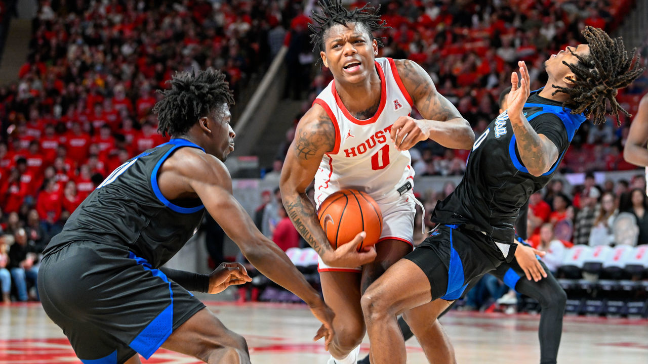 HOUSTON, TX - FEBRUARY 08: Houston Cougars guard Marcus Sasser (0) is fouled hard as he drives in to a trap during the basketball game between the Tulsa Golden Hurricanes and Houston Cougars at the Fertitta Center on February 8, 2023 in Houston, Texas.