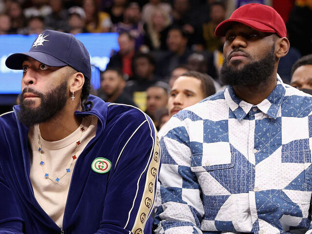 PHOENIX, ARIZONA - DECEMBER 19: (L-R) Russell Westbrook #0, Anthony Davis #3 and LeBron James #6 of the Los Angeles Lakers watch from the bench during the first half of the NBA game against the Phoenix Suns at Footprint Center on December 19, 2022 in Phoenix, Arizona.