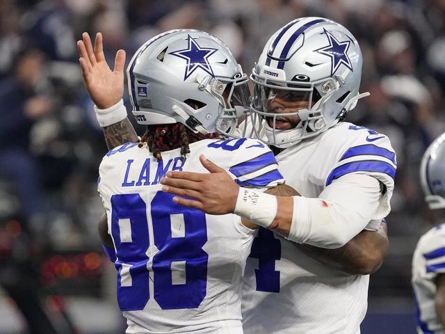 ARLINGTON, TEXAS - DECEMBER 24: CeeDee Lamb #88 of the Dallas Cowboys is congratulated by Dak Prescott #4 after scoring a touchdown during the second quarter of a game against the Philadelphia Eagles at AT&T Stadium on December 24, 2022 in Arlington, Texas.