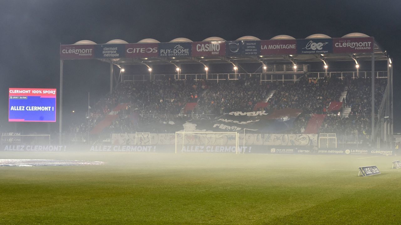 Tear gas smoke is pictured on the pitch and by the stands of the Gabriel-Montpied stadium as the French L1 football match between Clermont and Marseille was delayed due to clashes between supporters and the police had to use tear gas in Clermont-Ferrand on February 11, 2023.