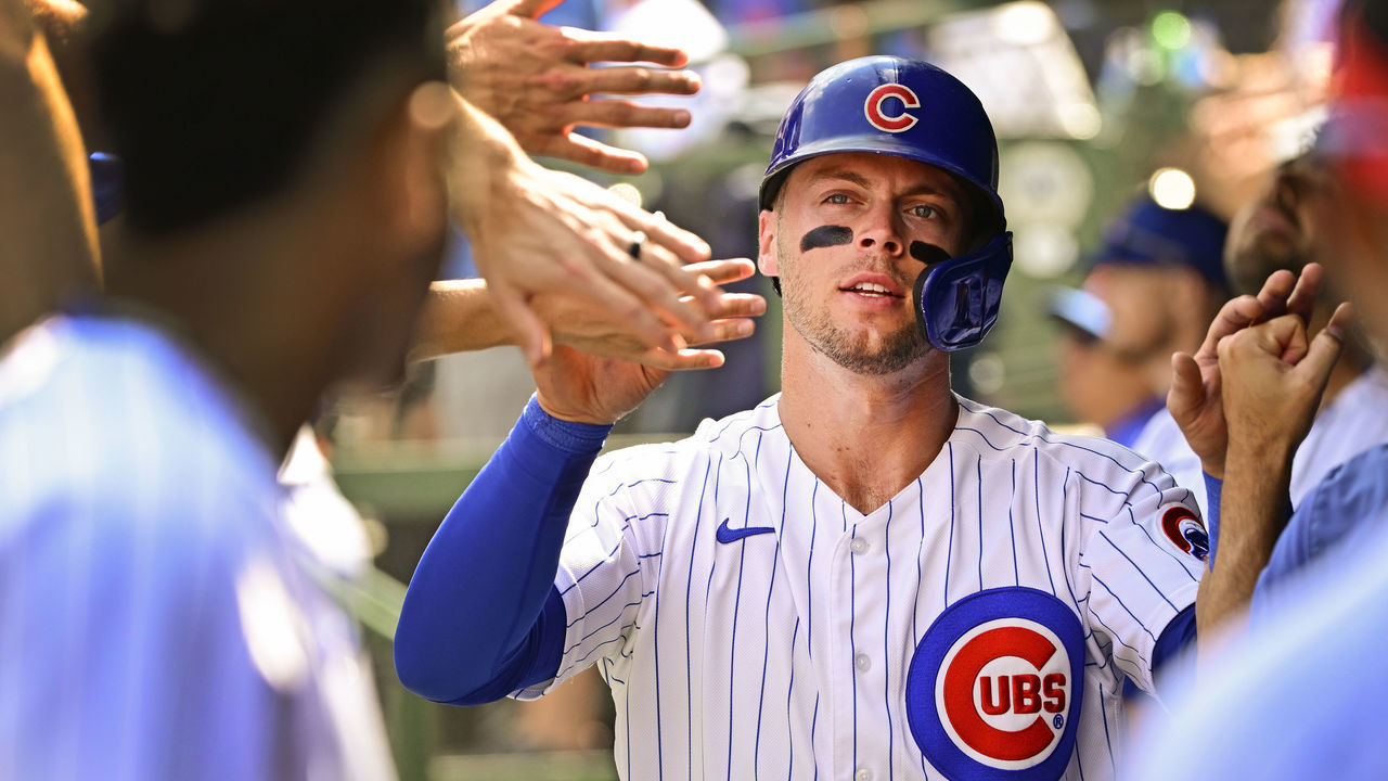 CHICAGO, ILLINOIS - SEPTEMBER 10: Nico Hoerner #2 of the Chicago Cubs celebrates in the dugout with teammates after scoring in the first inning against the San Francisco Giants at Wrigley Field on September 10, 2022 in Chicago, Illinois.
