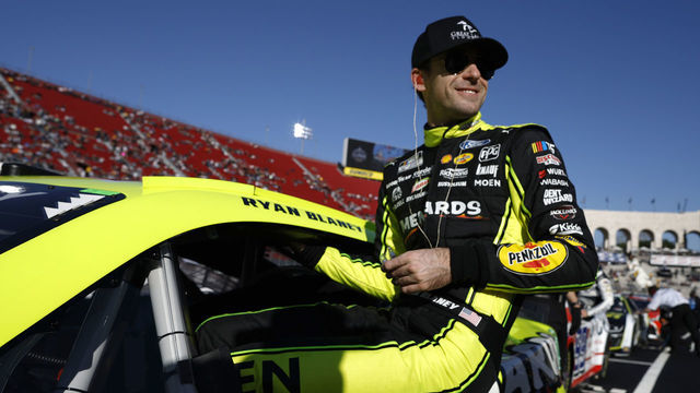 LOS ANGELES, CALIFORNIA - FEBRUARY 05: Ryan Blaney, driver of the #12 Menards/Great Lakes Flooring Ford, enters his car to race qualifying heat #3 for the NASCAR Clash at the Coliseum at Los Angeles Memorial Coliseum on February 05, 2023 in Los Angeles, California.