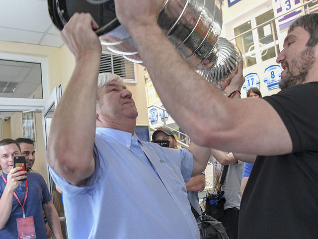MOSCOW, RUSSIA, July 7, 2018. Washington Capitals captain Alex Ovechkin hoists the cup with his father, Mikhail, when he sees the Cup for the first time at the Dynamo Hockey Club during his tour of his hometown with the Stanley Cup. (Photo by: Jonathan Newton/The Washington Post via Getty Images)