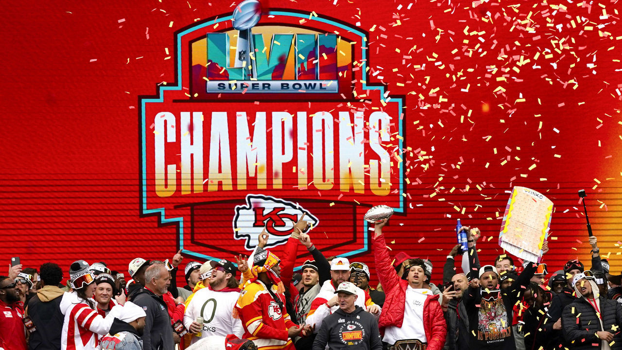 KANSAS CITY, MISSOURI - FEBRUARY 15: Patrick Mahomes #15 of the Kansas City Chiefs holds up the MVP trophy while celebrating with teammates during the Kansas City Chiefs Super Bowl LVII victory parade on February 15, 2023 in Kansas City, Missouri.