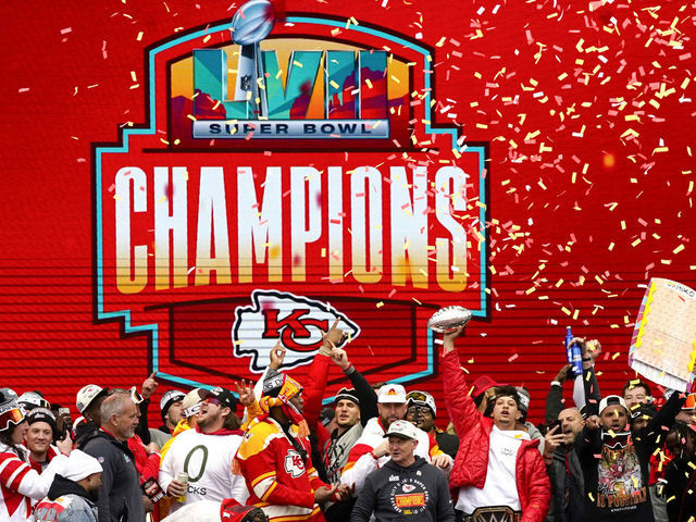 KANSAS CITY, MISSOURI - FEBRUARY 15: Patrick Mahomes #15 of the Kansas City Chiefs holds up the MVP trophy while celebrating with teammates during the Kansas City Chiefs Super Bowl LVII victory parade on February 15, 2023 in Kansas City, Missouri.