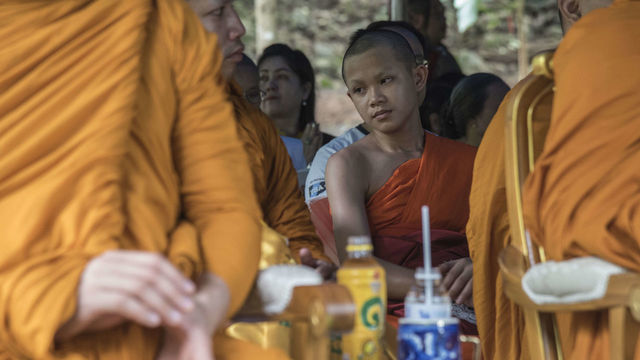 CHIANG RAI, THAILAND - 2018/08/03: Duangpetch Promthep (Dom), 13, a forward and captain of the Wild Boars football team attends a Buddhist ceremony at the entrance of Tham Luang cave. With 11 of his companions, he was ordained as a novice for 9 days after they were released from the hospital. Twelve boys, members of the football team "Wild Boars", aged 11 to 17 and their 25-year-old coach spent between 16 and 18 days in the Tham Luang cave in Northern Thailand where they got trapped by a sudden water surge. They were extracted from the cave during an unprecedented daring mission involving Thai and foreign divers.