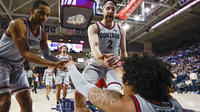 SPOKANE, WA - JANUARY 19: Gonzaga Bulldogs forward Drew Timme (2) and Gonzaga Bulldogs guard Nolan Hickman (11) help Gonzaga Bulldogs guard Julian Strawther (0) up during the game between the Loyola Marymount Lions and the Gonzaga Bulldogs on January 19, 2023, at McCarthey Athletic Center in Spokane, WA.