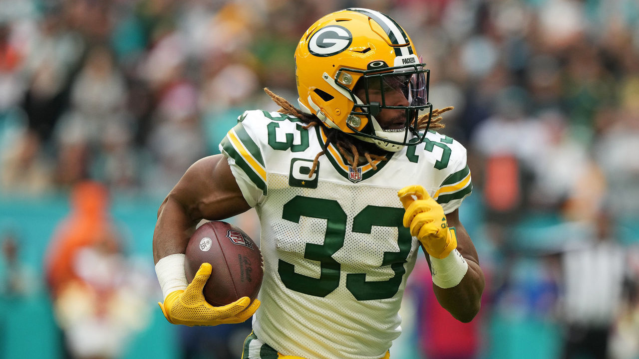 MIAMI GARDENS, FLORIDA - DECEMBER 25: Aaron Jones #33 of the Green Bay Packers rushes the ball during the first quarter of the game against the Miami Dolphins at Hard Rock Stadium on December 25, 2022 in Miami Gardens, Florida.