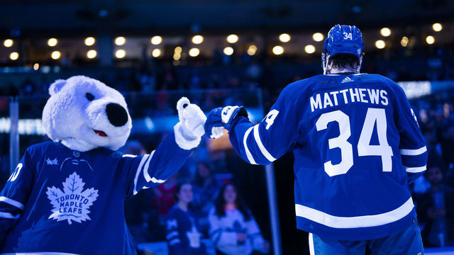 TORONTO, ON - FEBRUARY 15: Auston Matthews #34 of the Toronto Maple Leafs fist bumps mascot Carlton the Bear after receiving a star of the game after defeating the Chicago Blackhawks at the Scotiabank Arena on February 15, 2023 in Toronto, Ontario, Canada.