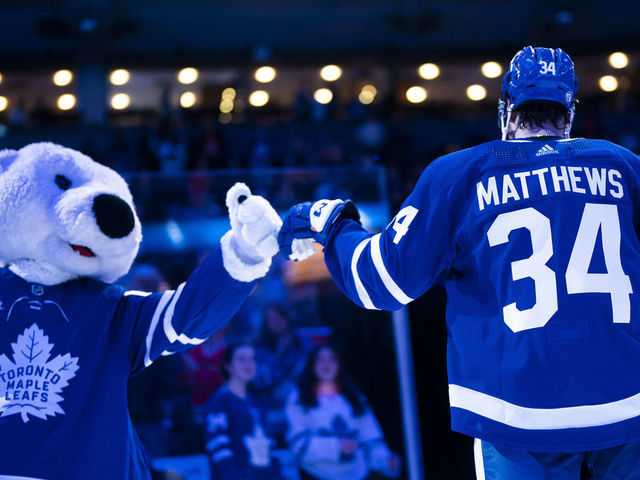 TORONTO, ON - FEBRUARY 15: Auston Matthews #34 of the Toronto Maple Leafs fist bumps mascot Carlton the Bear after receiving a star of the game after defeating the Chicago Blackhawks at the Scotiabank Arena on February 15, 2023 in Toronto, Ontario, Canada.