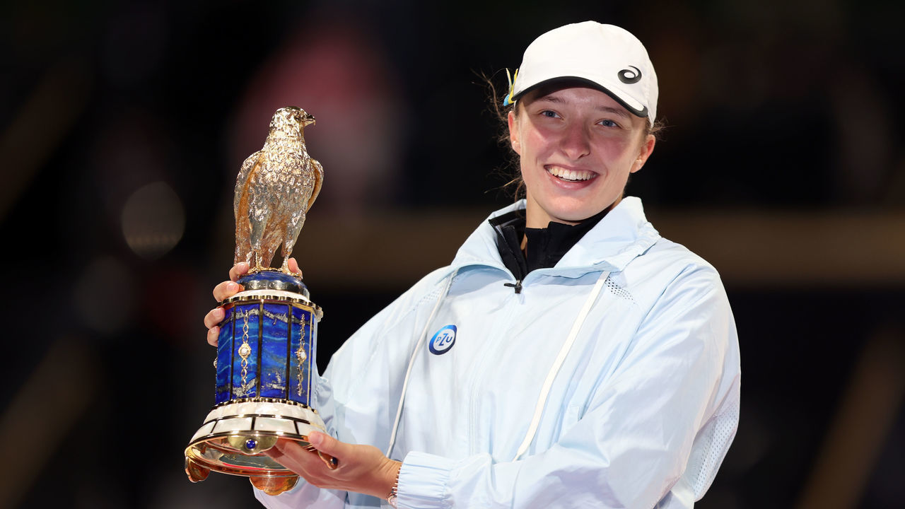 DOHA, QATAR - FEBRUARY 18: Iga Swiatek of Poland celebrates with the trophy on the podium after defeating Jessica Pegula of USA in the final match on day six of the Qatar Total Energies Open, part of the Hologic WTA Tour, at Khalifa International Tennis and Squash Complex on February 18, 2023 in Doha, Qatar.