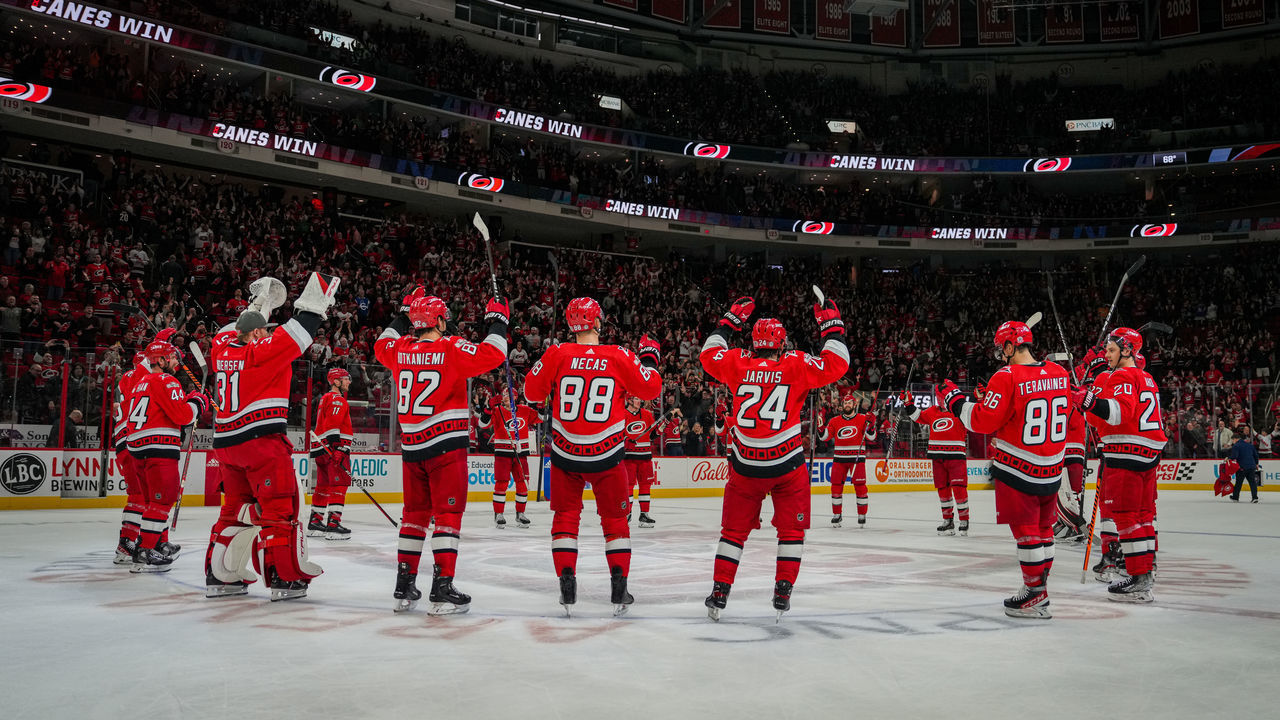 RALEIGH, NORTH CAROLINA - FEBRUARY 16: The Carolina Hurricanes celebrate with the Storm Surge after defeating the Montreal Canadiens at PNC Arena on February 16, 2023 in Raleigh, North Carolina.