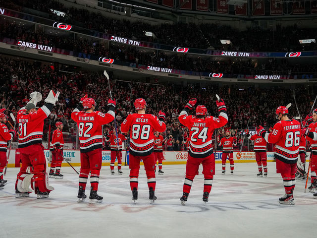 RALEIGH, NORTH CAROLINA - FEBRUARY 16: The Carolina Hurricanes celebrate with the Storm Surge after defeating the Montreal Canadiens at PNC Arena on February 16, 2023 in Raleigh, North Carolina.