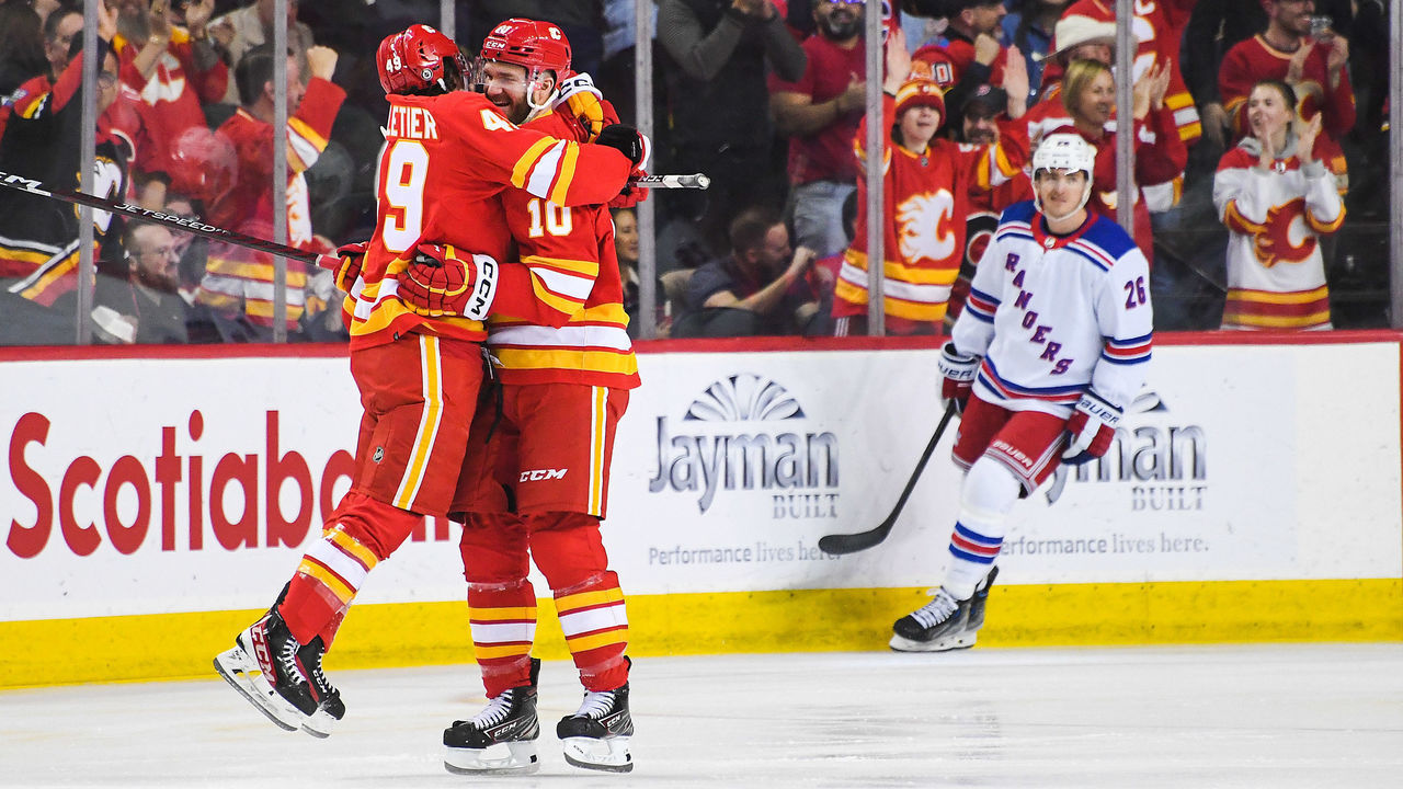 CALGARY, CANADA - FEBRUARY 18: Jakob Pelletier #49 (L) and Jonathan Huberdeau #10 of the Calgary Flames celebrate after their second goal by Nazem Kadri #91 (not pictured) against the New York Rangers during the first period of an NHL game at Scotiabank Saddledome on February 18, 2023 in Calgary, Alberta, Canada.