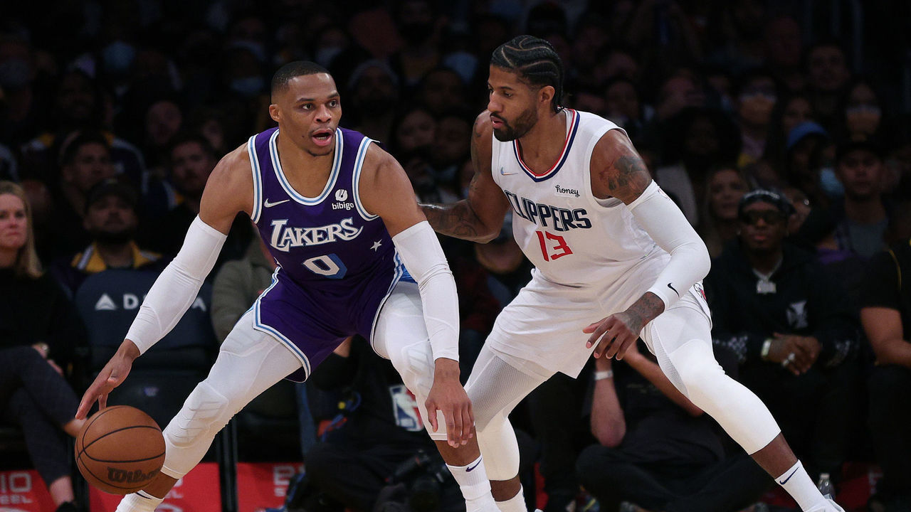 LOS ANGELES, CALIFORNIA - DECEMBER 03: Russell Westbrook #0 of the Los Angeles Lakers is defended by Paul George #13 of the LA Clippers during a 119-115 Clippers win at Staples Center on December 03, 2021 in Los Angeles, California. NOTE TO USER: User expressly acknowledges and agrees that, by downloading and/or using this Photograph, user is consenting to the terms and conditions of the Getty Images License Agreement. Mandatory Copyright Notice: Copyright 2021 NBAE