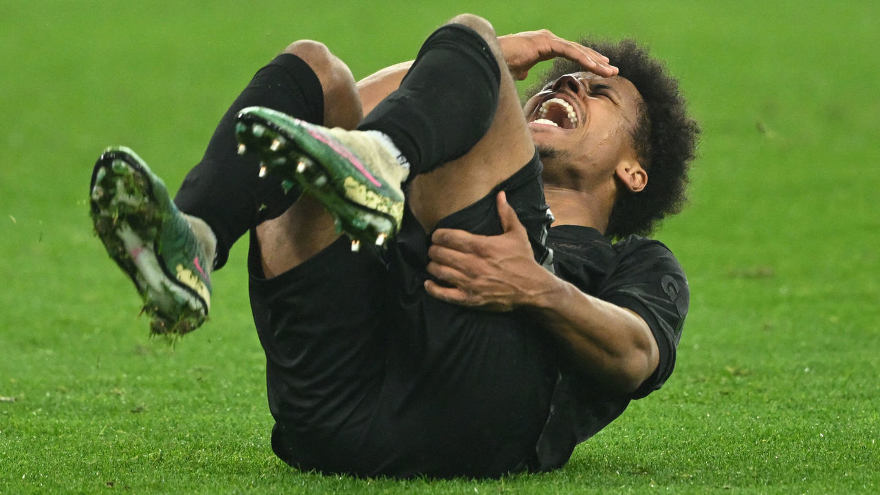 Dortmund's German forward Karim Adeyemi screams after sustaining an injury during the German first division Bundesliga football match between Borussia Dortmund and Hertha Berlin in Dortmund on February 19, 2023. - DFL REGULATIONS PROHIBIT ANY USE OF PHOTOGRAPHS AS IMAGE SEQUENCES AND/OR QUASI-VIDEO