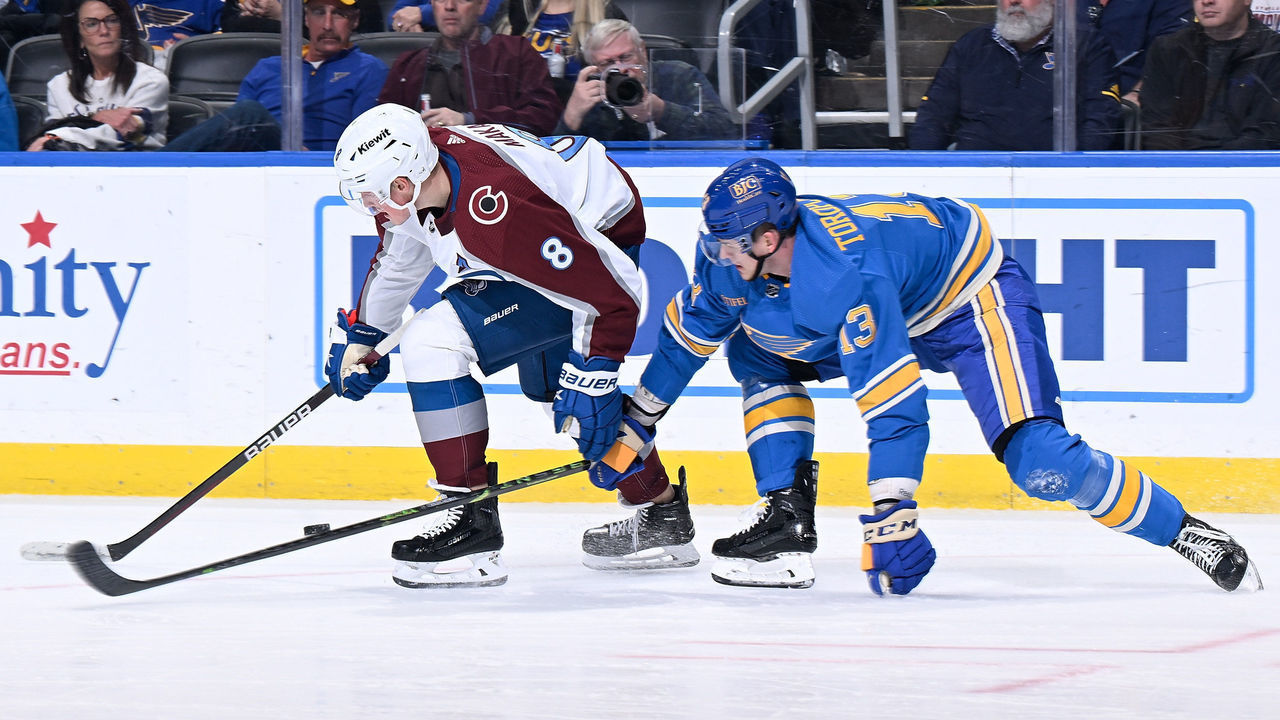 ST. LOUIS, MO - FEBRUARY 18: Cale Makar #8 of the Colorado Avalanche and Alexey Toropchenko #13 of the St. Louis Blues battle for control of the puck at the Enterprise Center on February 18, 2023 in St. Louis, Missouri.