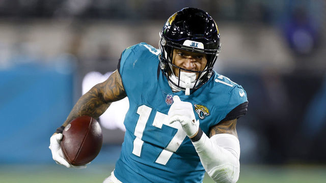 JACKSONVILLE, FLORIDA - JANUARY 14: Evan Engram #17 of the Jacksonville Jaguars carries the ball against the Los Angeles Chargers during the second half of the game in the AFC Wild Card playoff game at TIAA Bank Field on January 14, 2023 in Jacksonville, Florida.