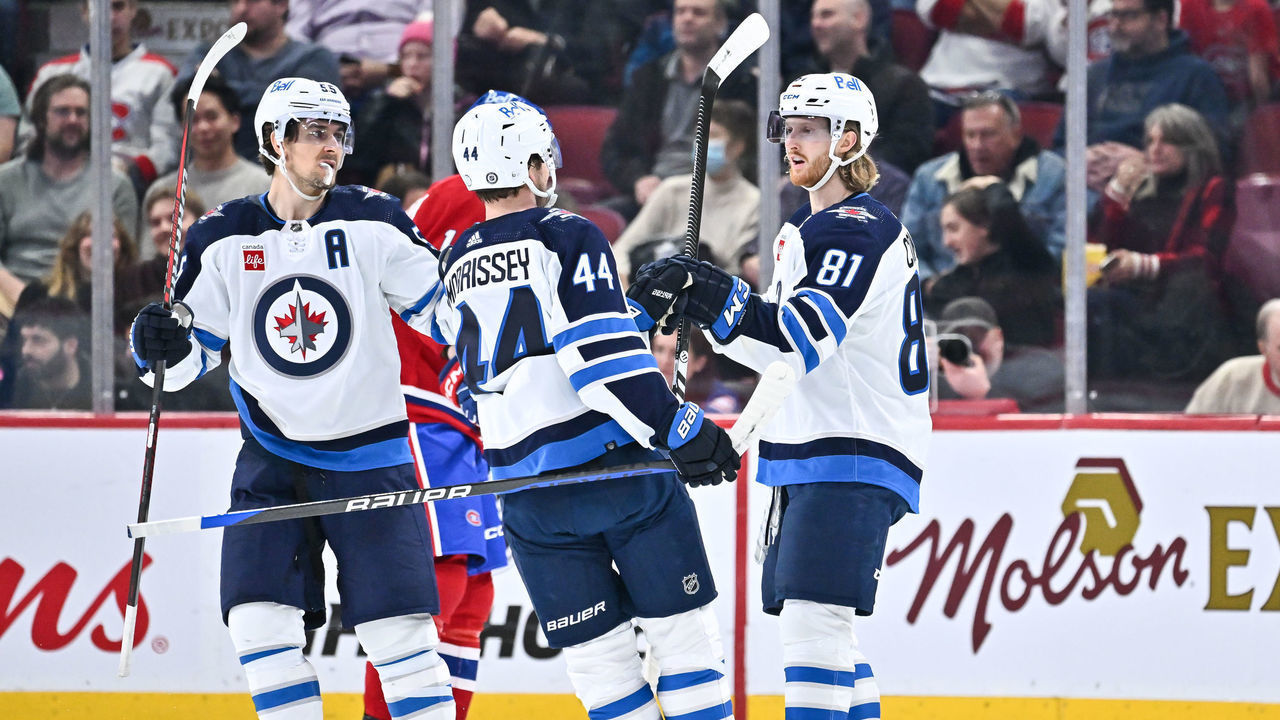 MONTREAL, CANADA - JANUARY 17: Kyle Connor #81 of the Winnipeg Jets celebrates his 200th career NHL goal with teammates Josh Morrissey #44 and Mark Scheifele #55 during the second period against the Montreal Canadiens at Centre Bell on January 17, 2023 in Montreal, Quebec, Canada. The Montreal Canadiens defeated the Winnipeg Jets 4-1.