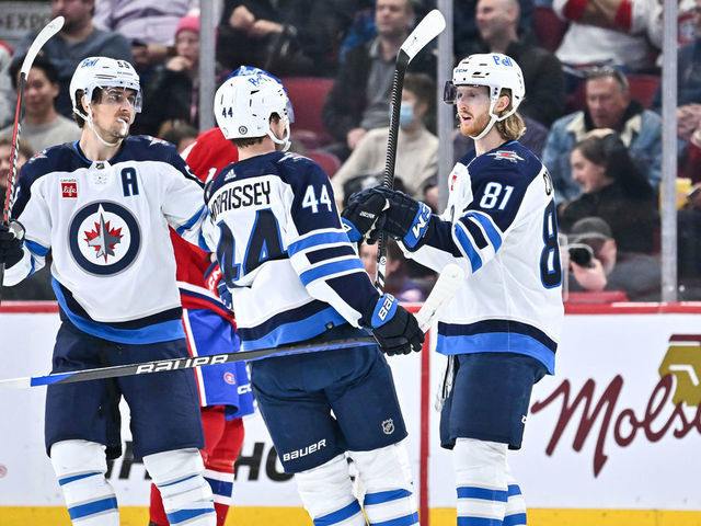 MONTREAL, CANADA - JANUARY 17: Kyle Connor #81 of the Winnipeg Jets celebrates his 200th career NHL goal with teammates Josh Morrissey #44 and Mark Scheifele #55 during the second period against the Montreal Canadiens at Centre Bell on January 17, 2023 in Montreal, Quebec, Canada. The Montreal Canadiens defeated the Winnipeg Jets 4-1.