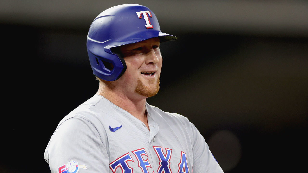 HOUSTON, TEXAS - SEPTEMBER 05: Kole Calhoun #56 of the Texas Rangers reacts to being walked during the fifth inning against the Houston Astros at Minute Maid Park on September 05, 2022 in Houston, Texas.