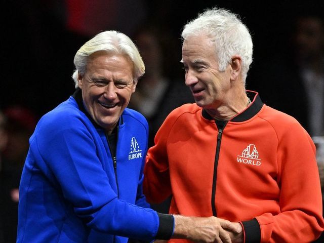 Team Europe captain Bjorn Borg (L) shares a joke with Team World captain John McEnroe (R) on Day 2 of the 2022 Laver Cup at the O2 Arena in London on September 24, 2022. - RESTRICTED TO EDITORIAL USE