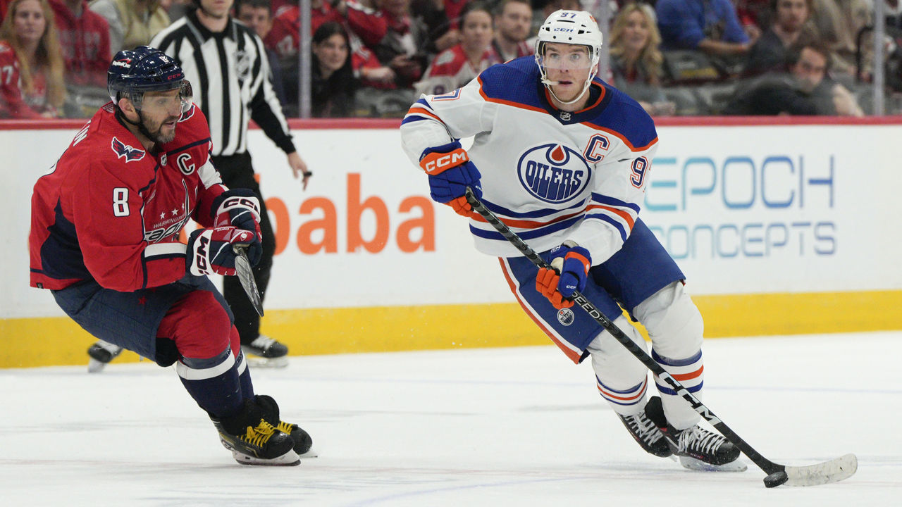 WASHINGTON, DC - NOVEMBER 07: Connor McDavid #97 of the Edmonton Oilers skates with the puck as Alex Ovechkin #8 of the Washington Capitals defends during the third period at Capital One Arena on November 07, 2022 in Washington, DC. This is McDavid's 500th career game.