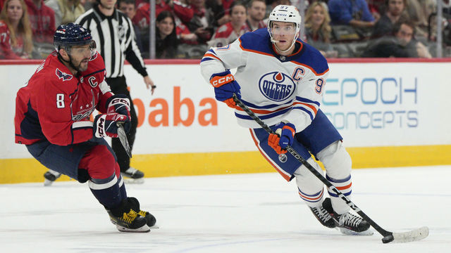 WASHINGTON, DC - NOVEMBER 07: Connor McDavid #97 of the Edmonton Oilers skates with the puck as Alex Ovechkin #8 of the Washington Capitals defends during the third period at Capital One Arena on November 07, 2022 in Washington, DC. This is McDavid's 500th career game.