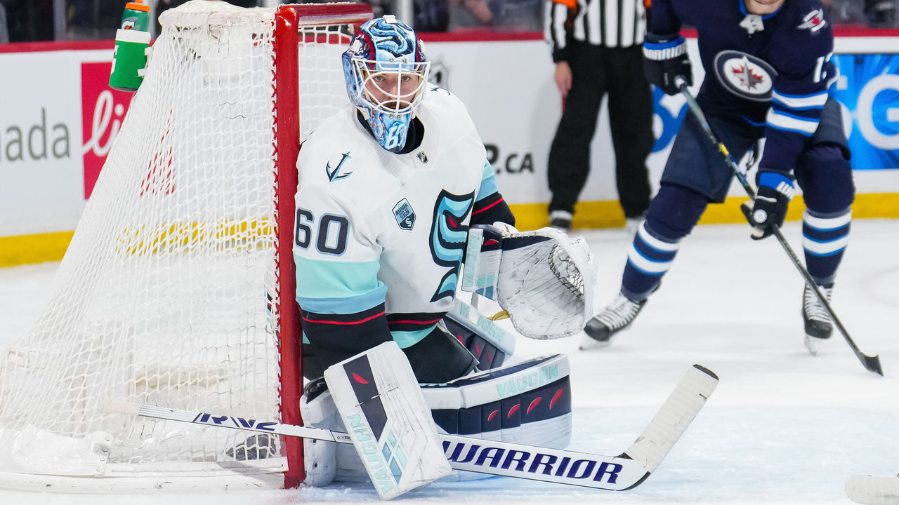 WINNIPEG, MANITOBA - MAY 01: Chris Driedger #60 of the Seattle Kraken hugs the post during the second period of a game against the Winnipeg Jets at Canada Life Centre on May 01, 2022 in Winnipeg, Manitoba.