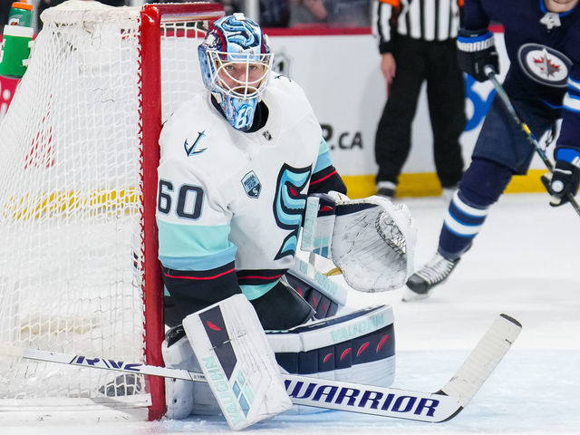 WINNIPEG, MANITOBA - MAY 01: Chris Driedger #60 of the Seattle Kraken hugs the post during the second period of a game against the Winnipeg Jets at Canada Life Centre on May 01, 2022 in Winnipeg, Manitoba.