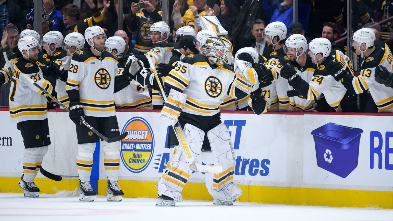 VANCOUVER, CANADA - FEBRUARY 25: Linus Ullmark #35 of the Boston Bruins is congratulated at the player's bench after scoring a goal into an empty net against the Vancouver Canucks during the third period of their NHL game at Rogers Arena on February 25, 2023 in Vancouver, British Columbia, Canada.