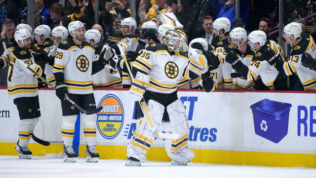 VANCOUVER, CANADA - FEBRUARY 25: Linus Ullmark #35 of the Boston Bruins is congratulated at the player's bench after scoring a goal into an empty net against the Vancouver Canucks during the third period of their NHL game at Rogers Arena on February 25, 2023 in Vancouver, British Columbia, Canada.