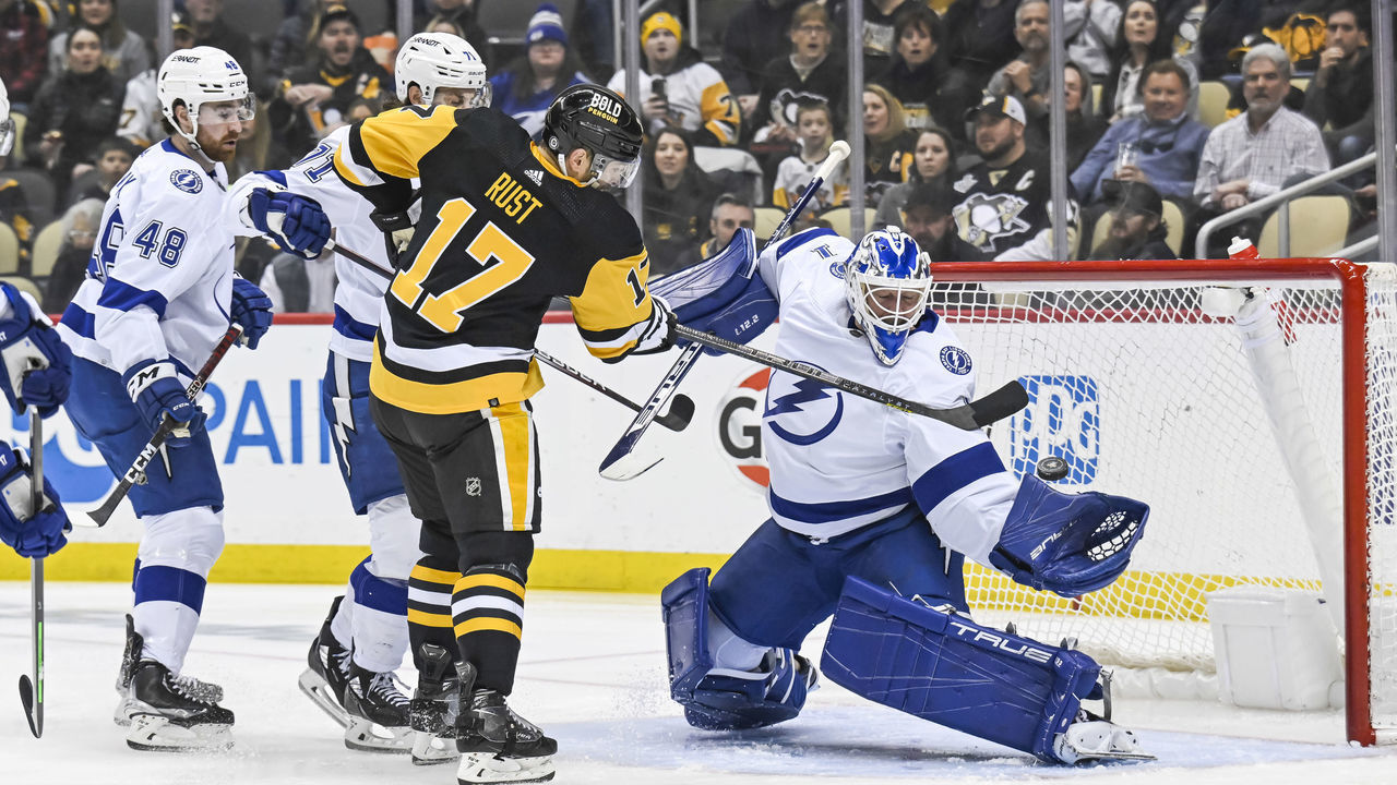 PITTSBURGH, PA - FEBRUARY 26:Tampa Bay Lightning Goalie Brian Elliott (1) makes a save on Pittsburgh Penguins Right Wing Bryan Rust (17) in front during the first period in the NHL game between the Pittsburgh Penguins and the Tampa Bay Lightning on February 26, 2023, at PPG Paints Arena in Pittsburgh, PA.