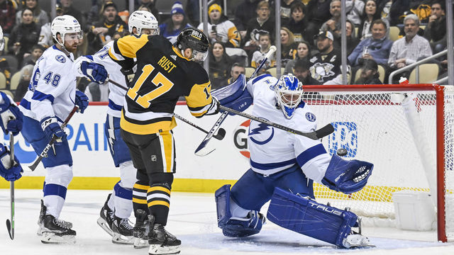 PITTSBURGH, PA - FEBRUARY 26:Tampa Bay Lightning Goalie Brian Elliott (1) makes a save on Pittsburgh Penguins Right Wing Bryan Rust (17) in front during the first period in the NHL game between the Pittsburgh Penguins and the Tampa Bay Lightning on February 26, 2023, at PPG Paints Arena in Pittsburgh, PA.