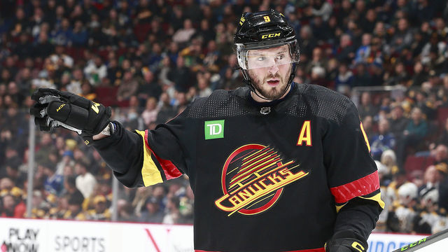 VANCOUVER, CANADA - FEBRUARY 25: J.T. Miller #9 of the Vancouver Canucks lines up for a face-off during their NHL game against the Boston Bruins at Rogers Arena February 25, 2023 in Vancouver, British Columbia, Canada.